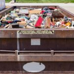 Garbage, trash or waste dumpster full of household junk. Concept of cleaning, cleanup, hoarding and disposal